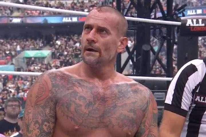 Security Escorts CM Punk Back To His Dressing Room Following...